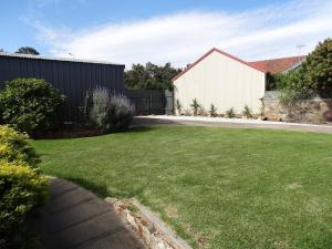 a yard with a fence and a house at Beach Living at Its Best in McCracken