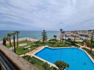 a swimming pool with a view of the ocean at 1HAB en Castillo Santa Clara in Torremolinos