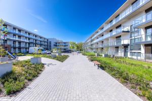 a walkway in front of an apartment building at Apartament Classic Spa&Wellness by Major Domus Club in Dziwnów