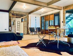 a living room with a bed and a table and chairs at Whitewater Byron Bay in Byron Bay