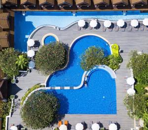 a mural of a swimming pool on the side of a building at Diamond Cottage Resort & Spa in Karon Beach