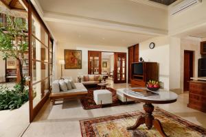 a living room with a couch and a table at Jimbaran Beach Villas by Nakula in Jimbaran