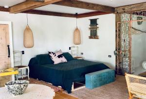 a bedroom with a bed with a blue comforter at Whitewater Byron Bay in Byron Bay