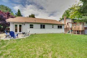 a white house with a playground in the yard at Centrally Located Reno Retreat with Patio and Yard in Reno