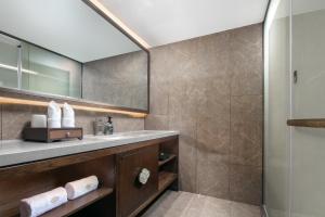 a bathroom with a sink and a shower at Till Bright Hotel, Changsha Provincial Museum in Changsha