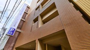 a building with a parking sign on the side of it at Toyoko Inn Osaka Namba Nippombashi in Osaka +32 photos