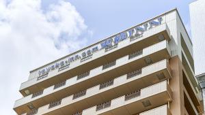 a building with a sign on the side of it at Toyoko Inn Osaka Namba Nippombashi in Osaka