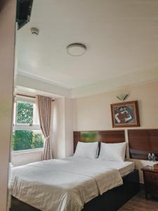 Ліжко або ліжка в номері Minh Trang Motel