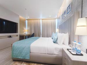 Postel nebo postele na pokoji v ubytování Mariton Hotel