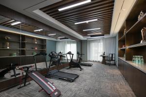 a gym with treadmills and exercise equipment in a room at Till Bright Hotel, Changsha Provincial Museum in Changsha