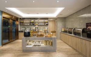 a restaurant with a counter with food on display at Morninginn, Radio and Television Center Xianglong Metro Station in Xingsha