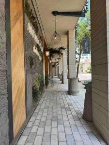 an empty hallway of a building with a walkway at Trendy, upscale apartment! in Houston