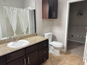 a bathroom with a sink and a toilet at Trendy, upscale apartment! in Houston +19 photos