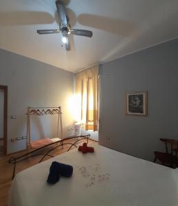 um quarto com uma cama e uma ventoinha de tecto em Nonna Giusy em Alghero
