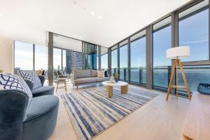 a living room with a couch and a table at ULTIQA Signature at Broadbeach in Gold Coast