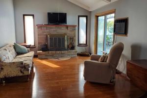 a living room with a couch and a fireplace at Serenity Sunset in Brocton