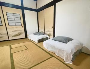 Postel nebo postele na pokoji v ubytování みんなでつくるふるさとウエダイラハウス + 37 fotografií