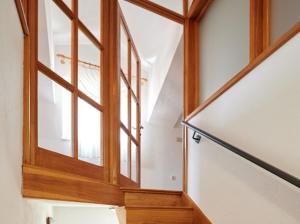 une cage d'escalier avec une porte en bois dans une maison dans l'établissement Guesthouse Ana Trogir Old Town, à Trogir