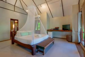 een slaapkamer met een bed met een klamboe bij Peter Pan Resort @ Koh Kood in Ko Kood