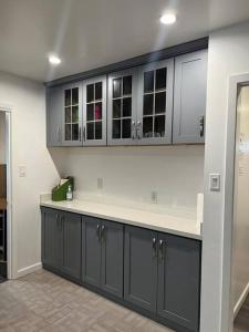 a kitchen with gray cabinets and a counter top at Affordable Private Rooms with Shared Bath Kitchen near SFO (SA) in Daly City