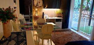 a kitchen with a table and chairs and a clock at For U 2 Stay in Pretoria