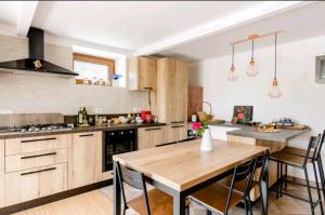 a kitchen with a wooden table and a dining room at Amrita Rosa in Castellamonte