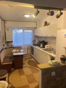 a kitchen with white cabinets and a table in it at Waves of the Sea in Mangalia