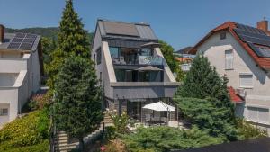 a house with solar panels on the side of it at Bazalt Apartman in Badacsonytomaj