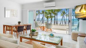 een woonkamer met uitzicht op de oceaan bij Belle Escapes presents 14 Alamanda Resort Where Pure Luxury meets the Coral Sea in Palm Cove
