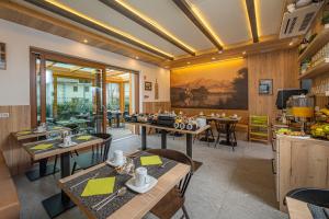 a restaurant with tables and chairs in a room at Veldes B&B in Bled
