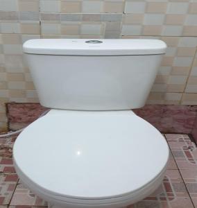 um WC branco sentado numa casa de banho em OYO 92714 Miracle Kost em Manado