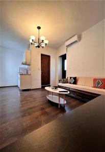 a living room with a couch and a table at Rias's Place in Kalamiós