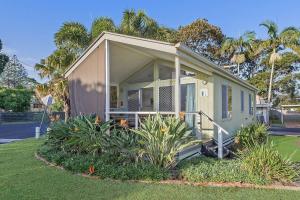 a small house with a porch and some plants at Reflections Massy Greene - Holiday Park in Brunswick Heads