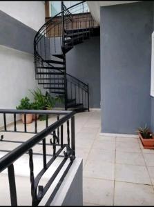 a spiral staircase in a building with plants at Apartamento a 5 minutos Zona Colonial in Santo Domingo