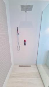 a shower in a white room with a toothbrush at Unforgettable 3BR Luxury Villa at Porter's Place in Saint James +35 photos