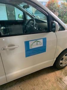 a white van with a sign on the side of it at Green Lodge Holiday Homes in Nuku‘alofa