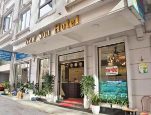 a new sun house with potted plants in front of it at New Sun Hotel in Ha Long