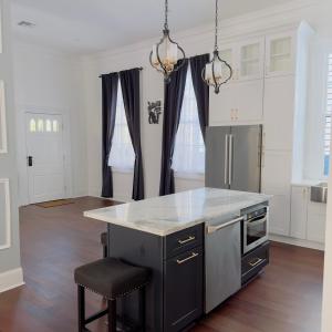 a kitchen with a counter and a island in it at Endless Story Magazine Suite Walk French Quarter in New Orleans