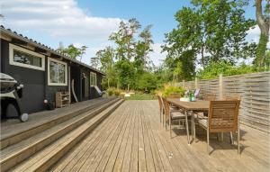 a deck with a table and chairs on a trailer at Gorgeous Home In Tranekr With Kitchen in Tranekær