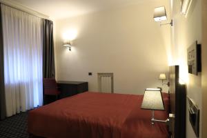 Posteľ alebo postele v izbe v ubytovaní Gemelli Hotel