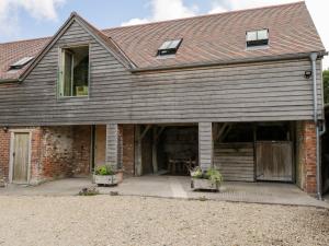 a large brick house with a garage at The Wool Barn in Warminster