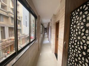 a corridor of a building with windows at Hotel Jodiya - Near CST in Mumbai