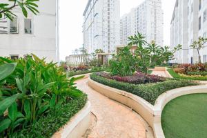 a garden in a city with tall buildings at RedLiving Apartemen Bassura City - Premium Property in Jakarta