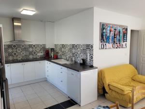 a kitchen with a sink and a counter top at Maison sur ile d'Oléron in Saint-Pierre-dʼOléron +1 photo