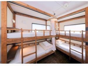 Postel nebo postele na pokoji v ubytování Sendai Guest House UMEBACHI