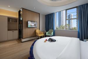 Una habitación de hotel con una cama grande y una ventana grande. en Morninginn, Malan Mountain Metro, en Changsha 19 fotos más