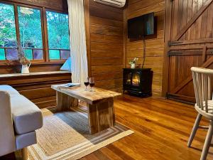 a living room with a table and a wood stove at Koompartoo Retreat Bellingen in Bellingen