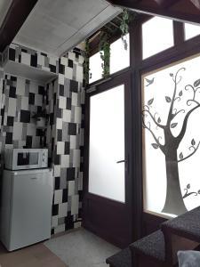 a kitchen with a tree mural on the wall at elefant in Baia Mare