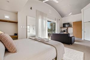 a bedroom with a large bed and a living room at 107 Apartments Margaret River in Margaret River Town