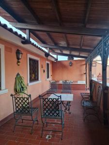 a patio with chairs and a table in a building at DOMUS SAN CARLO LOFT in Caserta +5 photos